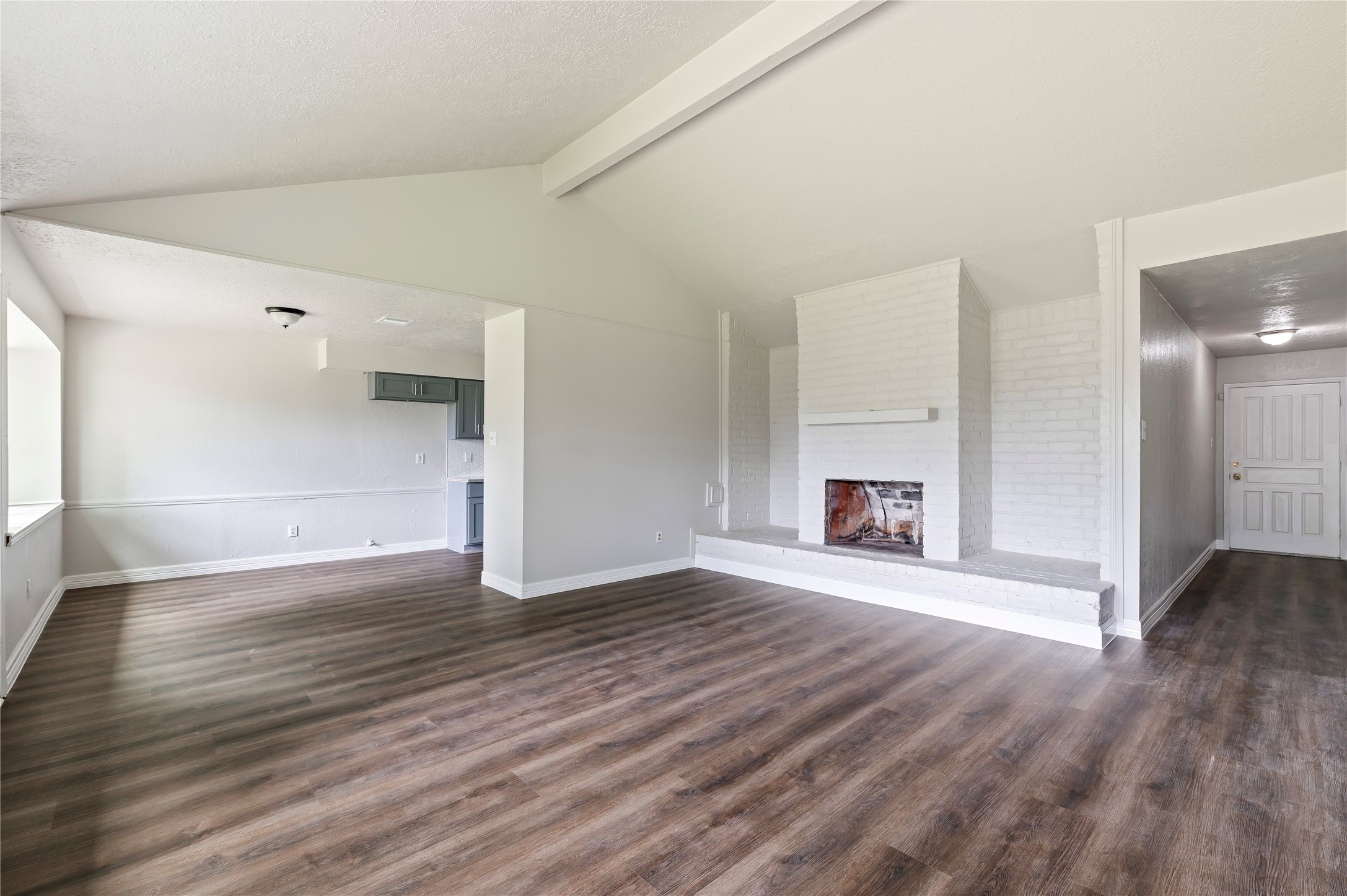 15050 Blueridge Road Missouri City, TX 77489 - Photo 6 of 30 an empty room with wooden floor and fireplace