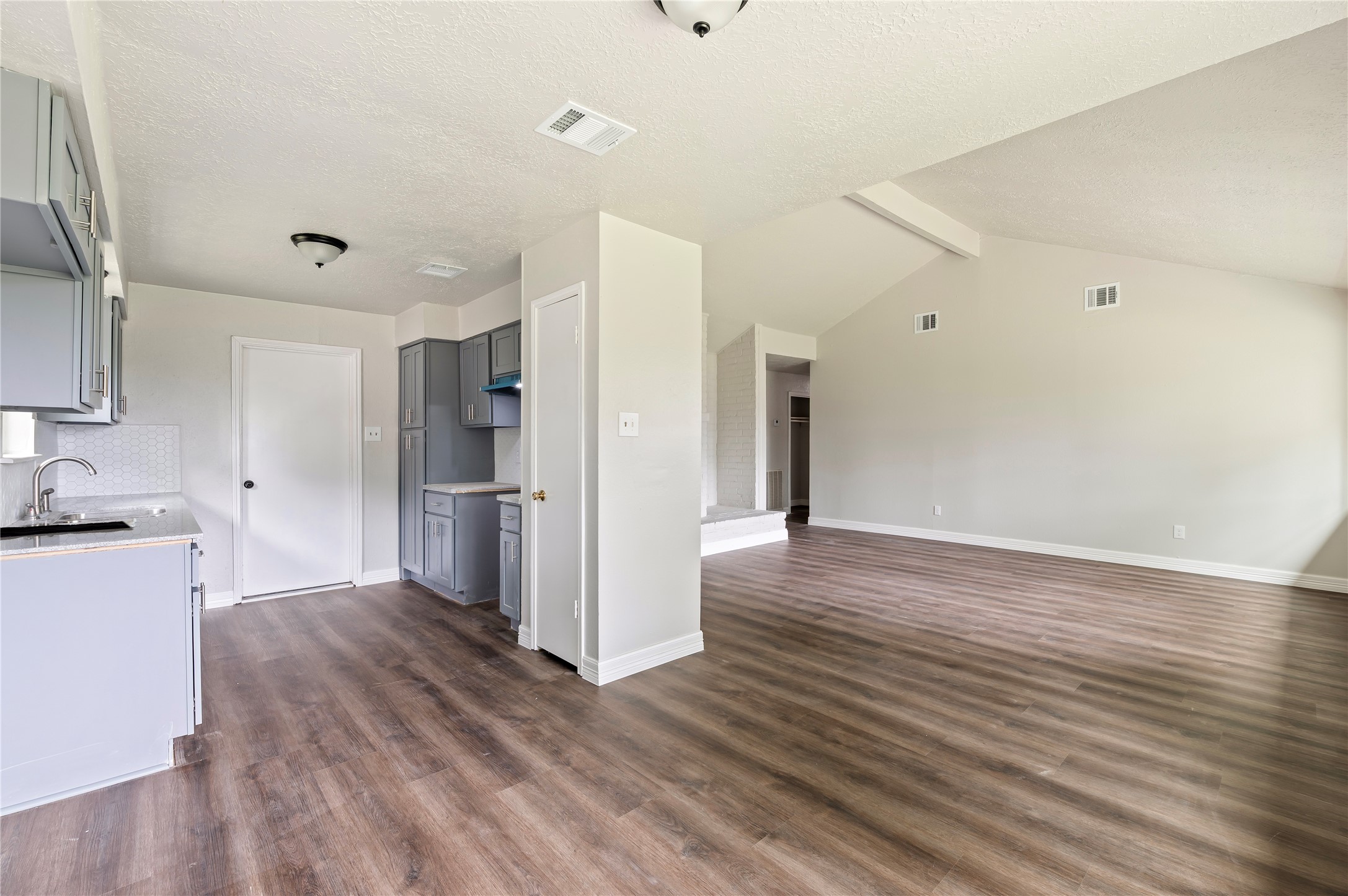 15050 Blueridge Road Missouri City, TX 77489 - Photo 9 of 30 a view of a kitchen with wooden floor and a sink