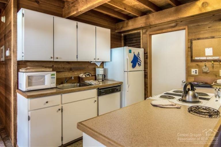 17 Ranch Cabin Road Sunriver, OR 97707 - Photo 5 of 23 a kitchen with a sink a stove and refrigerator