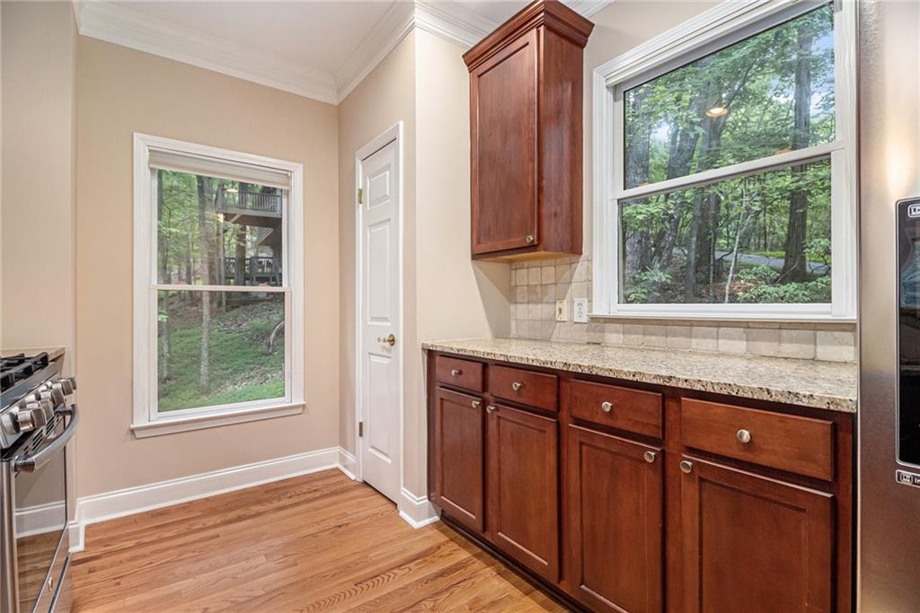 58 Poplar Circle Jasper, GA 30143 - Photo 14 of 31 a view of kitchen with granite countertop wooden cabinets a sink and a window