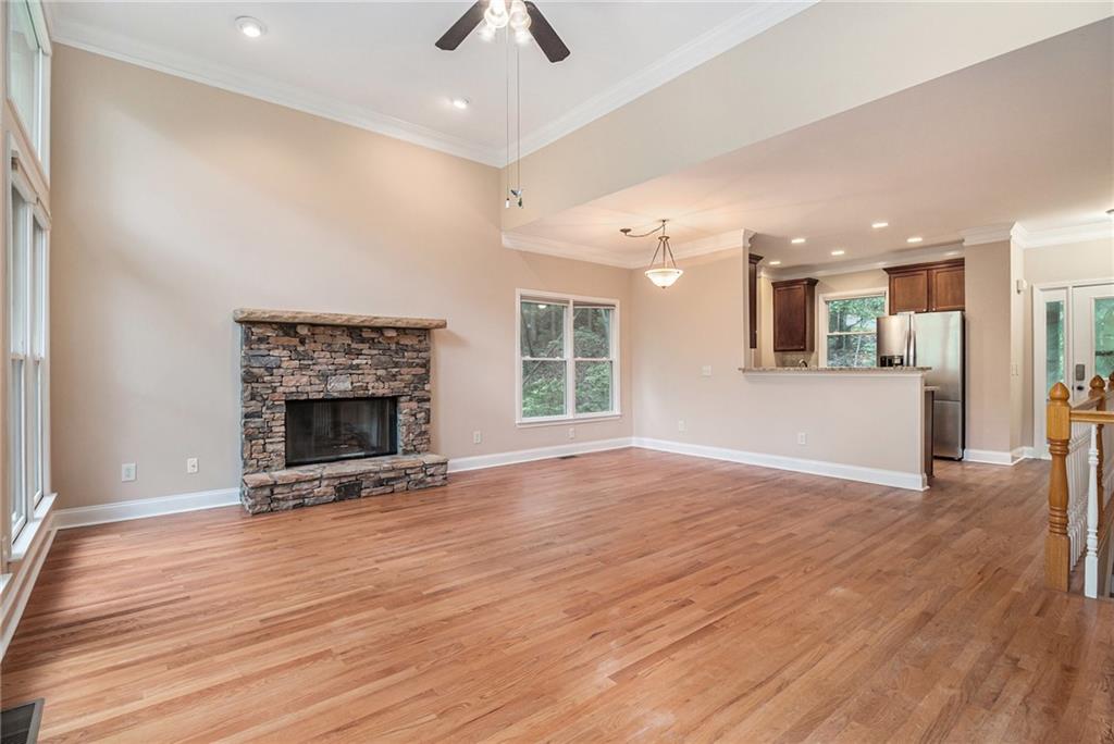 58 Poplar Circle Jasper, GA 30143 - Photo 6 of 31 an empty room with wooden floor a fireplace and window