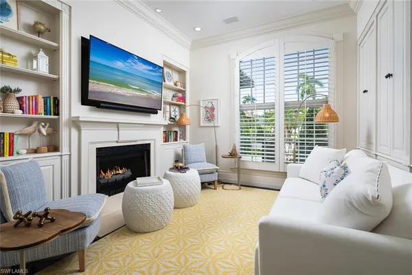 a living room with furniture fireplace and flat screen tv