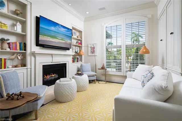 a living room with furniture fireplace and flat screen tv
