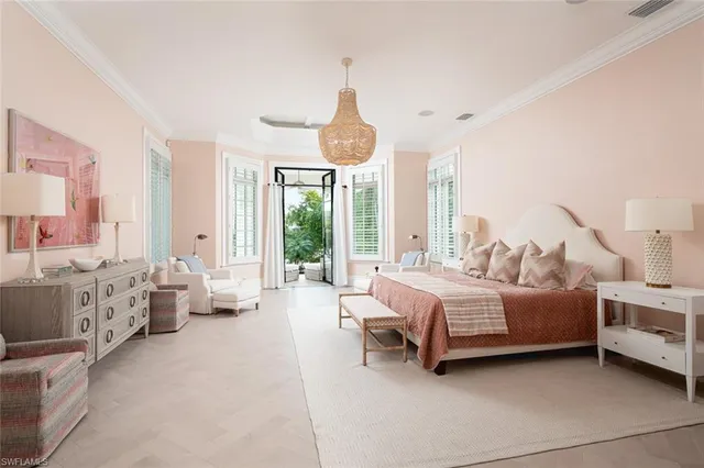 a spacious bedroom with a bed and large windows