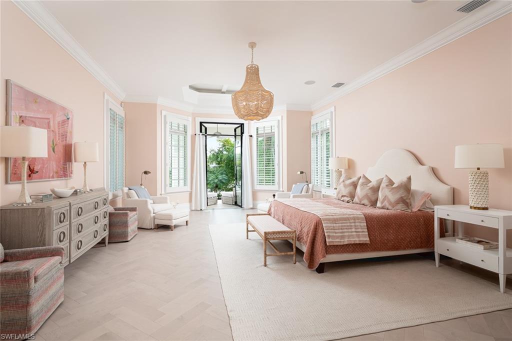 2595 Half Moon Walk Naples, FL 34102 - Photo 17 of 48 a spacious bedroom with a bed and large windows