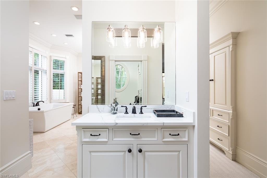 2595 Half Moon Walk Naples, FL 34102 - Photo 18 of 48 a bathroom with a sink vanity tub and a mirror