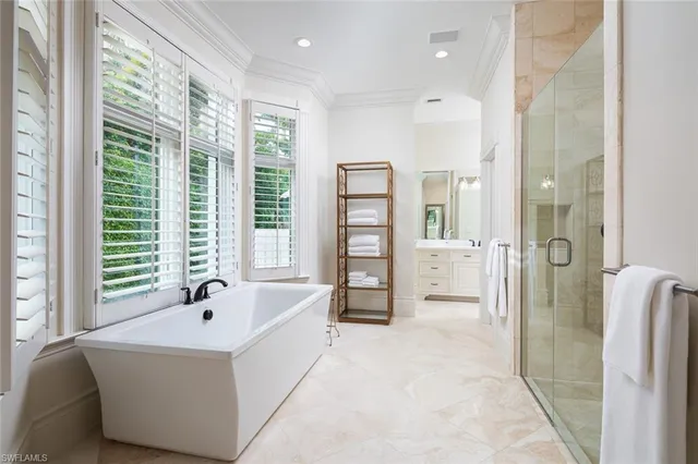 a spacious bathroom with a tub sink and shower