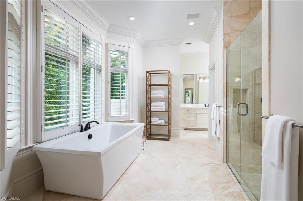 2595 Half Moon Walk Naples, FL 34102 - Photo 20 of 48 a spacious bathroom with a tub sink and shower