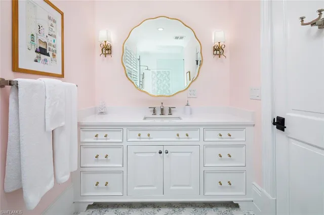 a bathroom with a sink mirror and vanity