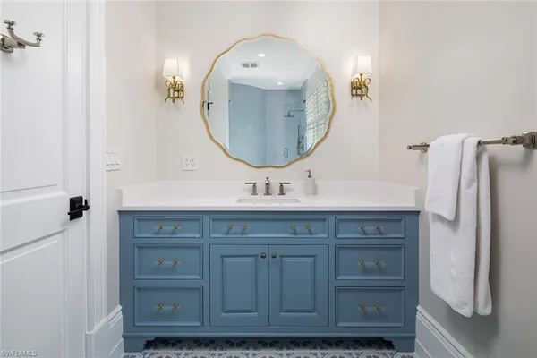 a bathroom with a double vanity sink and a mirror