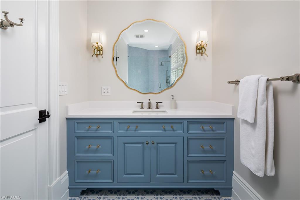 2595 Half Moon Walk Naples, FL 34102 - Photo 28 of 48 a bathroom with a double vanity sink and a mirror