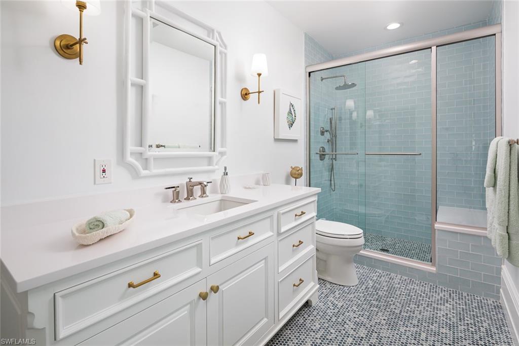 2595 Half Moon Walk Naples, FL 34102 - Photo 29 of 48 a bathroom with a granite countertop sink toilet and shower