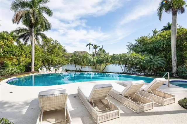 a view of backyard with swimming pool and outdoor seating