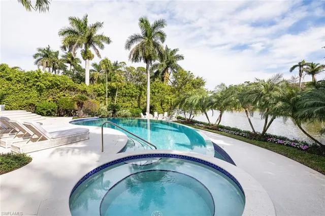 a swimming pool with trees in the background