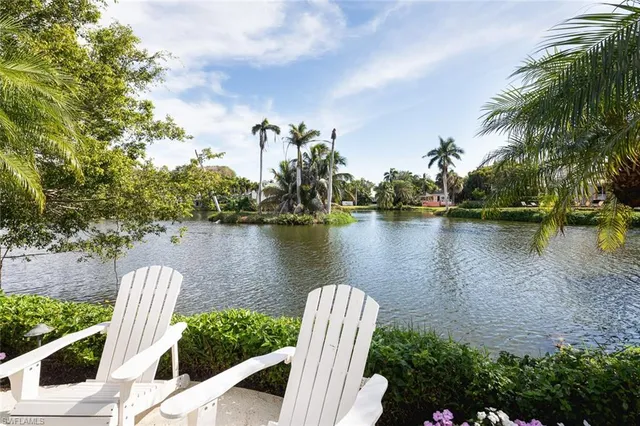 a view of a lake with houses in the back