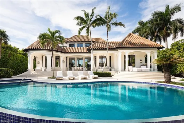 a house view with swimming pool and sitting space