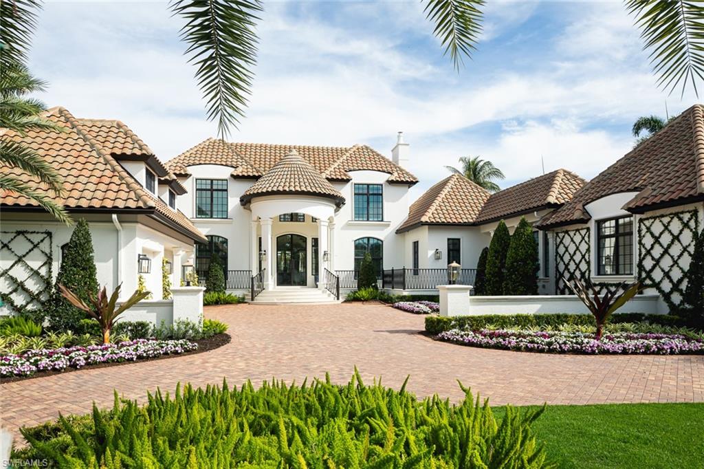 2595 Half Moon Walk Naples, FL 34102 - Photo 42 of 48 a front view of a house with a garden and plants