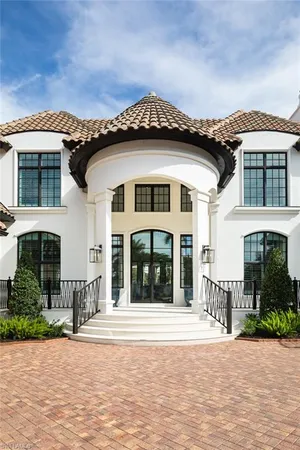 a front view of a house with a garden and plants