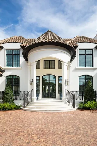 a front view of a house with a garden and plants