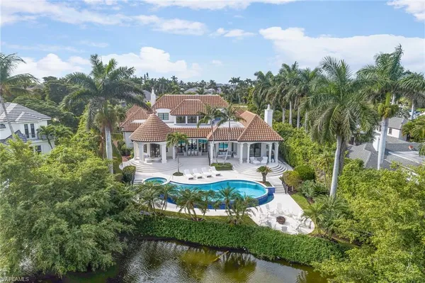 a front view of house with yard and lake view