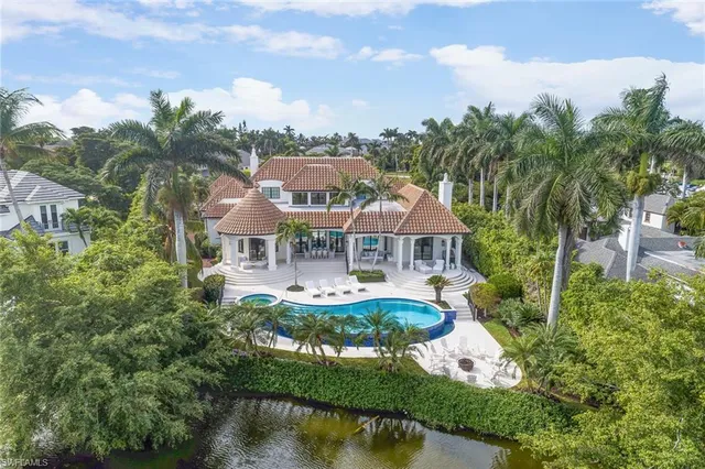 a front view of house with yard and lake view