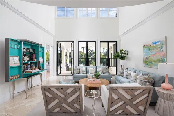 a living room with furniture and a floor to ceiling window