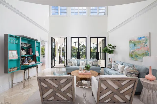 a living room with furniture and a floor to ceiling window