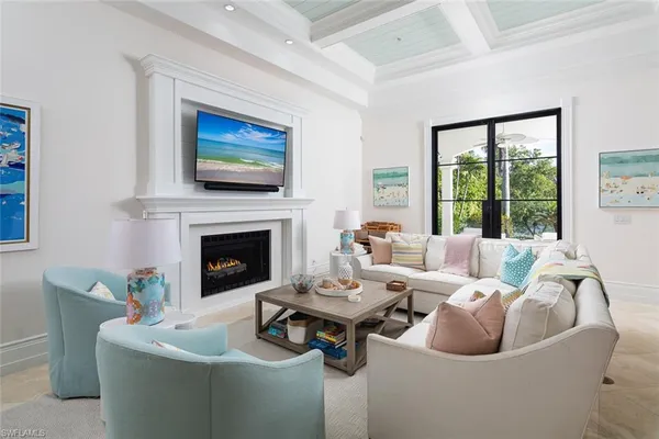 a living room with furniture a fireplace and a flat screen tv