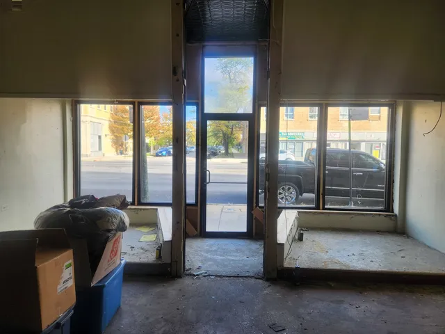 a living room with furniture and large windows