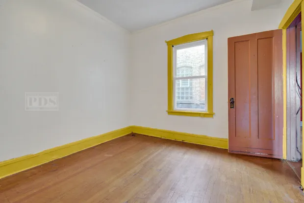 a view of a room with wooden floor and fan