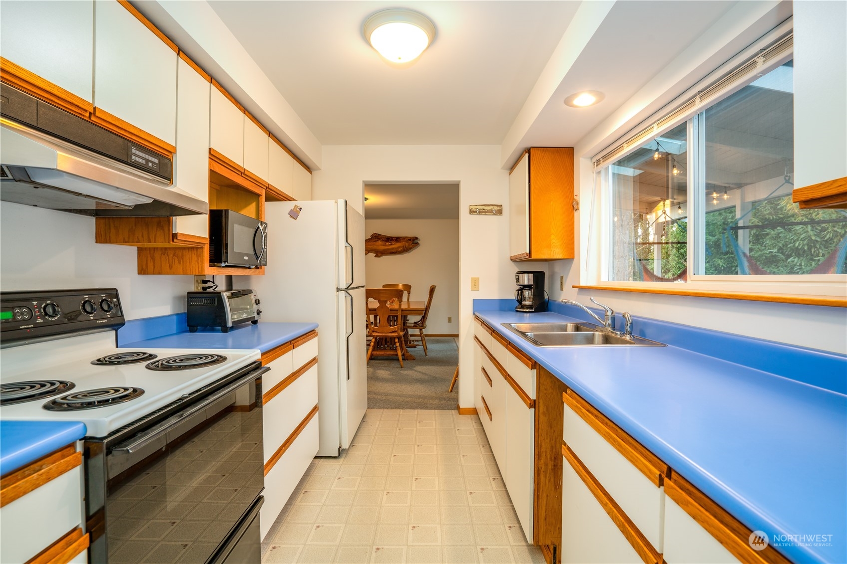 83-B Port Gardner Drive Hat Island, WA 98201 - Photo 13 of 33 a kitchen with a stove a sink and a refrigerator