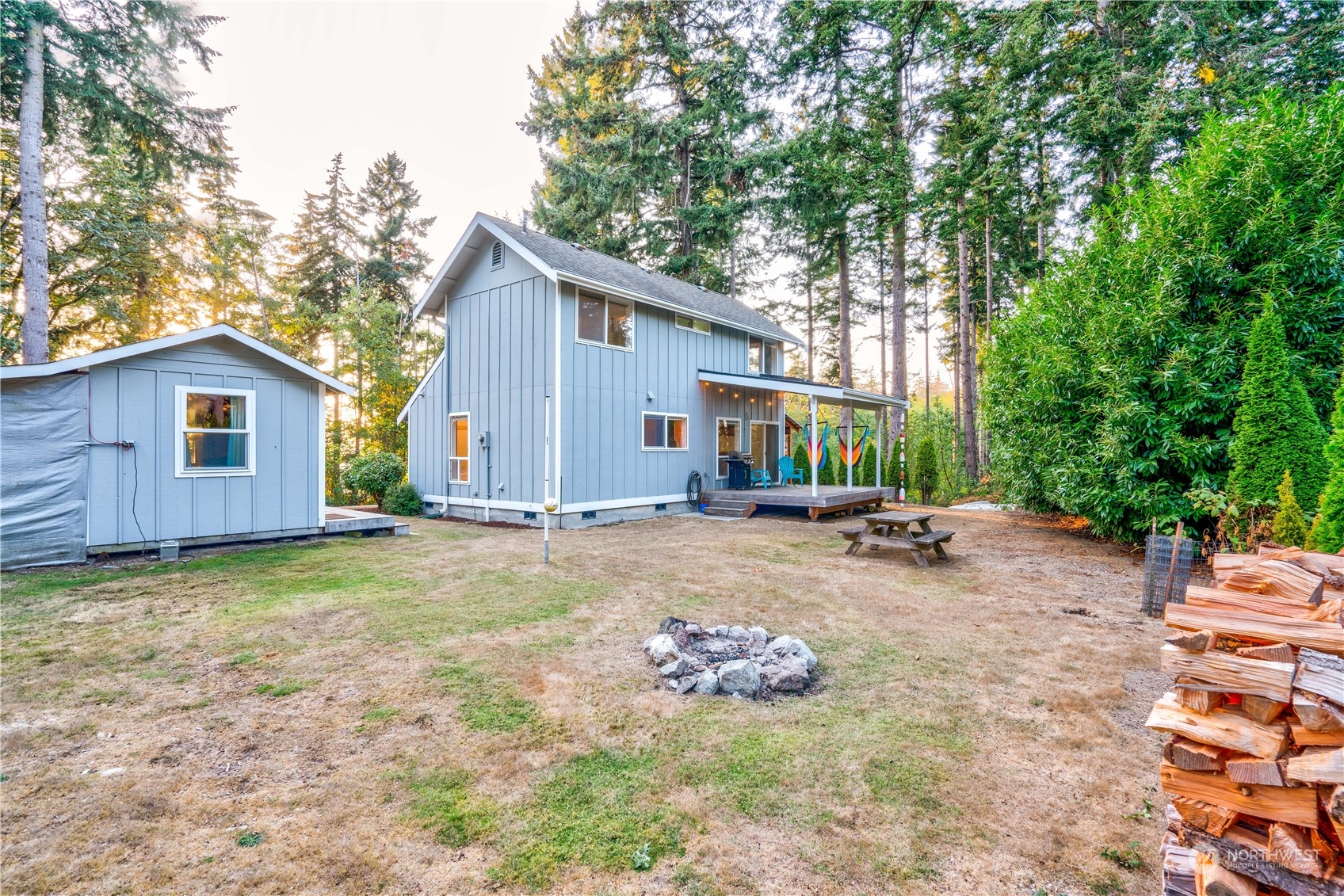 83-B Port Gardner Drive Hat Island, WA 98201 - Photo 22 of 33 a view of a house with backyard and trees