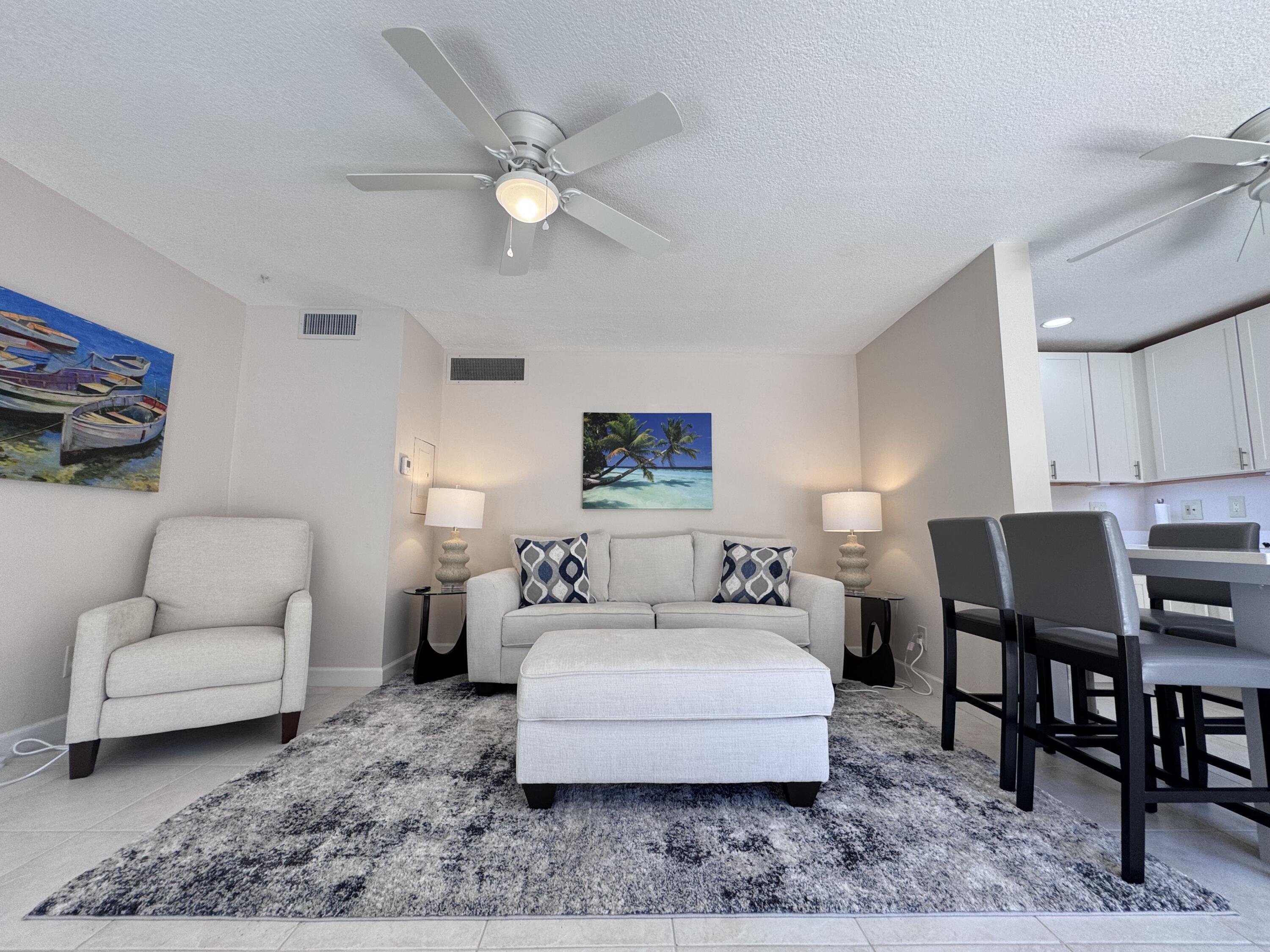 1605 Highway 1, Unit 1A Jupiter, FL 33477 - Photo 2 of 23 a living room with furniture a rug and a table