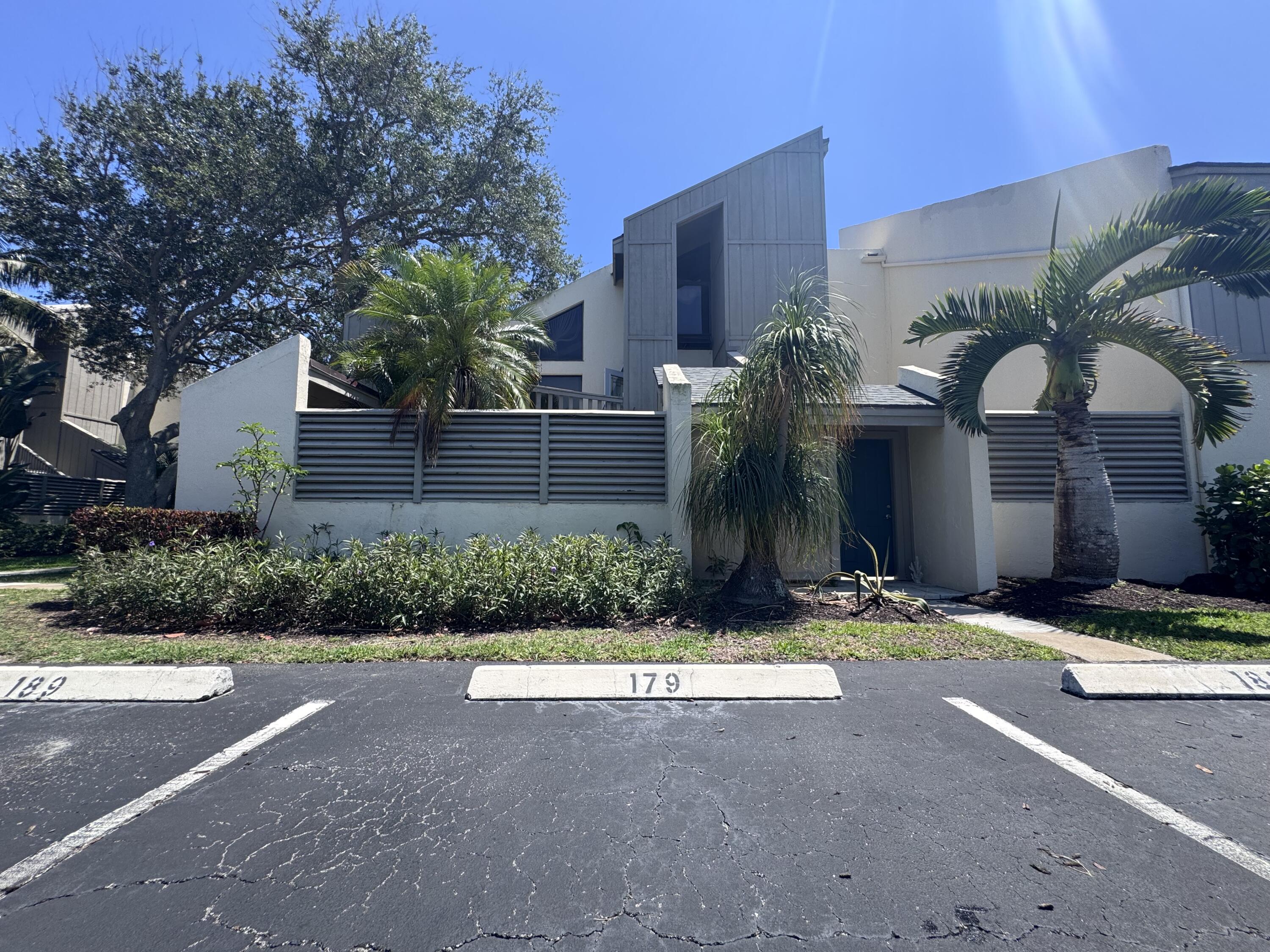1605 Highway 1, Unit 1A Jupiter, FL 33477 - Photo 22 of 23 a front view of a house with yard