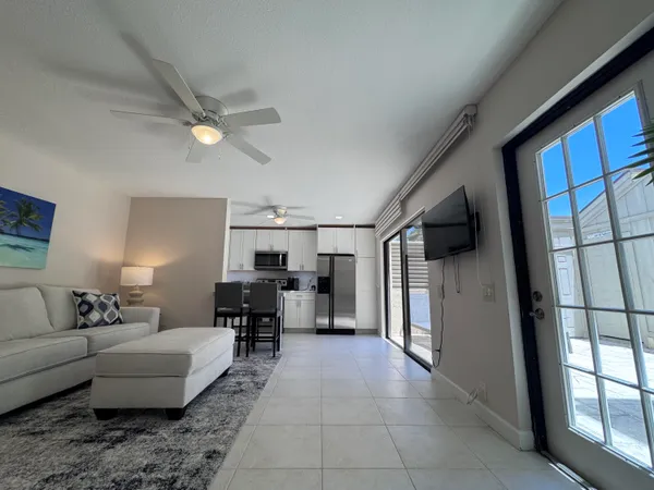 a living room with furniture a fireplace and a large window