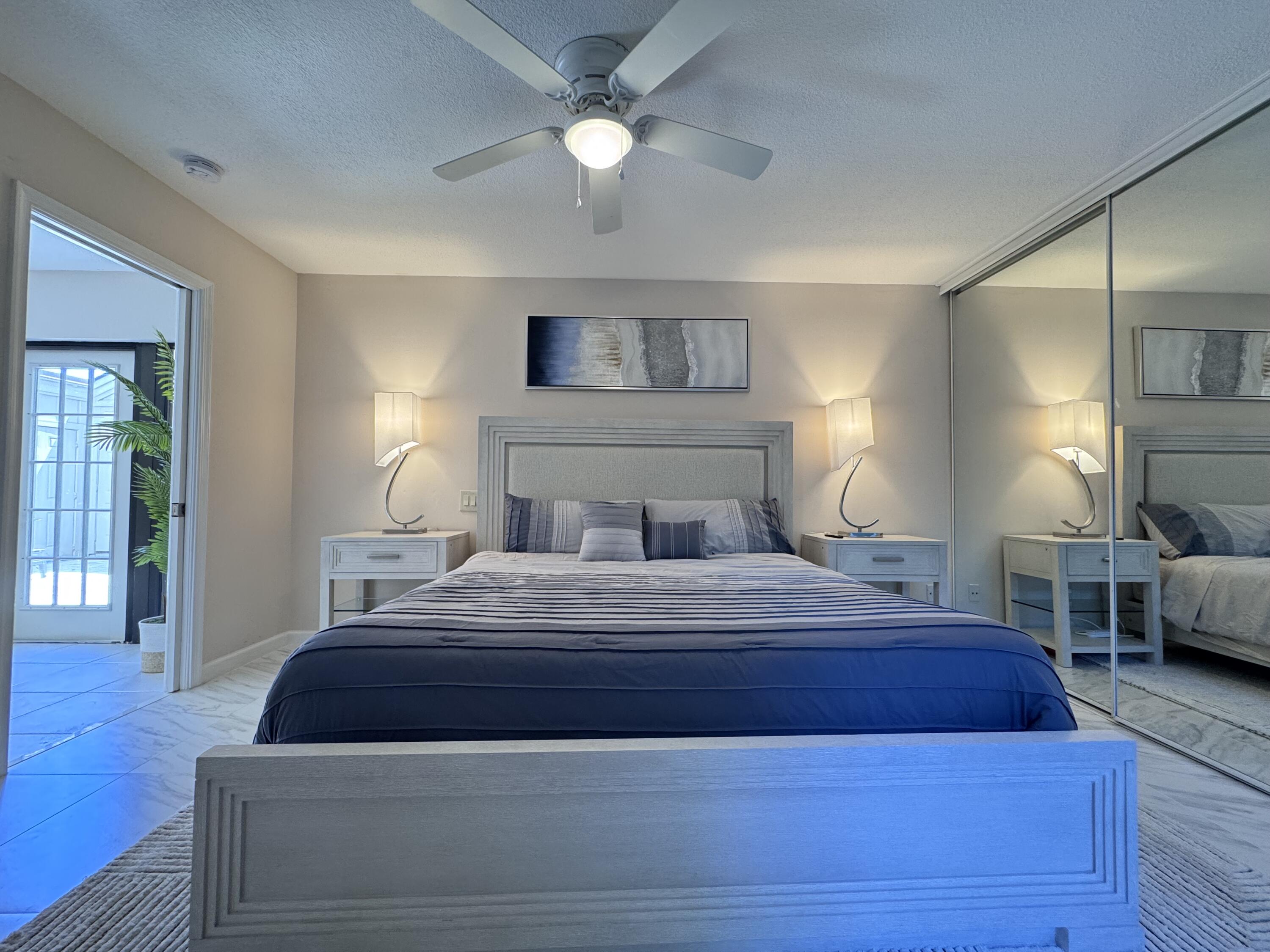 1605 Highway 1, Unit 1A Jupiter, FL 33477 - Photo 10 of 23 a bedroom with a bed and wooden floor