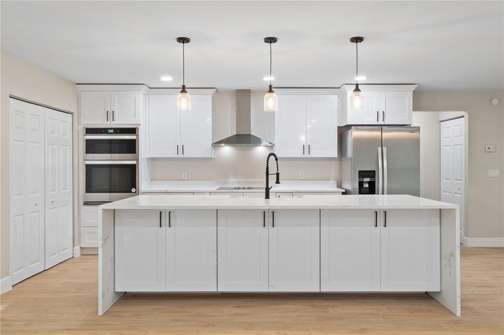 20045 Southwest 88th Place Road Dunnellon, FL 34431 - Photo 13 of 53 a kitchen with stainless steel appliances a sink a refrigerator a center island and cabinets