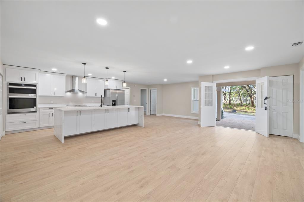 20045 Southwest 88th Place Road Dunnellon, FL 34431 - Photo 4 of 53 a view of a kitchen with a sink and dishwasher a refrigerator with wooden floor