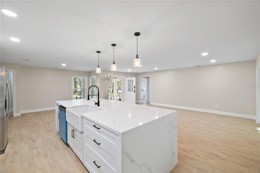 20045 Southwest 88th Place Road Dunnellon, FL 34431 - Photo 6 of 53 a large white kitchen with a sink a island and stainless steel appliances