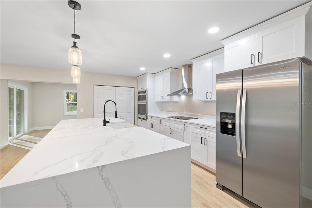 20045 Southwest 88th Place Road Dunnellon, FL 34431 - Photo 8 of 53 a large kitchen with stainless steel appliances kitchen island a refrigerator sink and cabinets