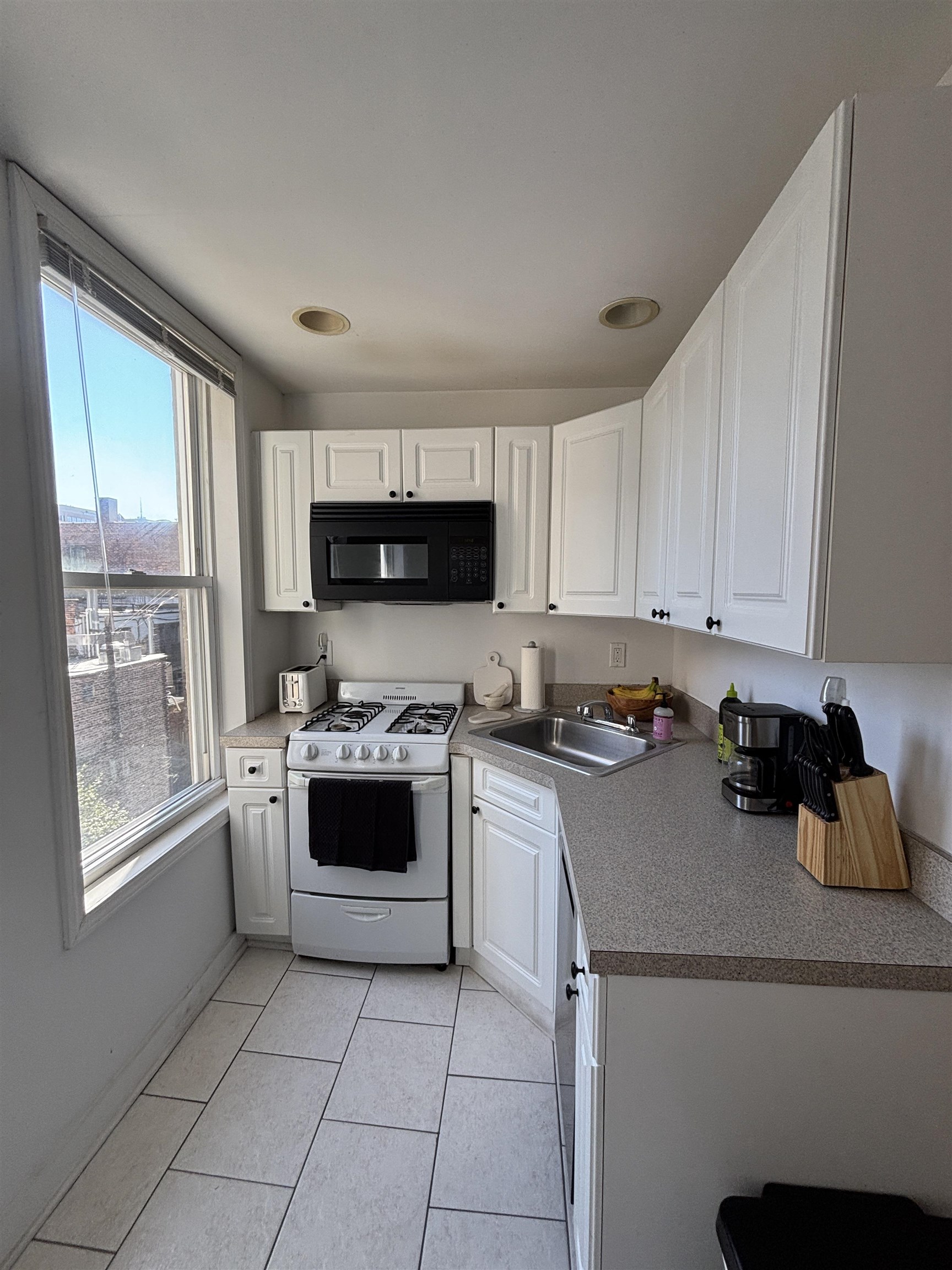 409 Bloomfield Street, Unit 8 Hoboken, NJ 07030 - Photo 2 of 5 a kitchen with a sink a stove top oven and cabinets