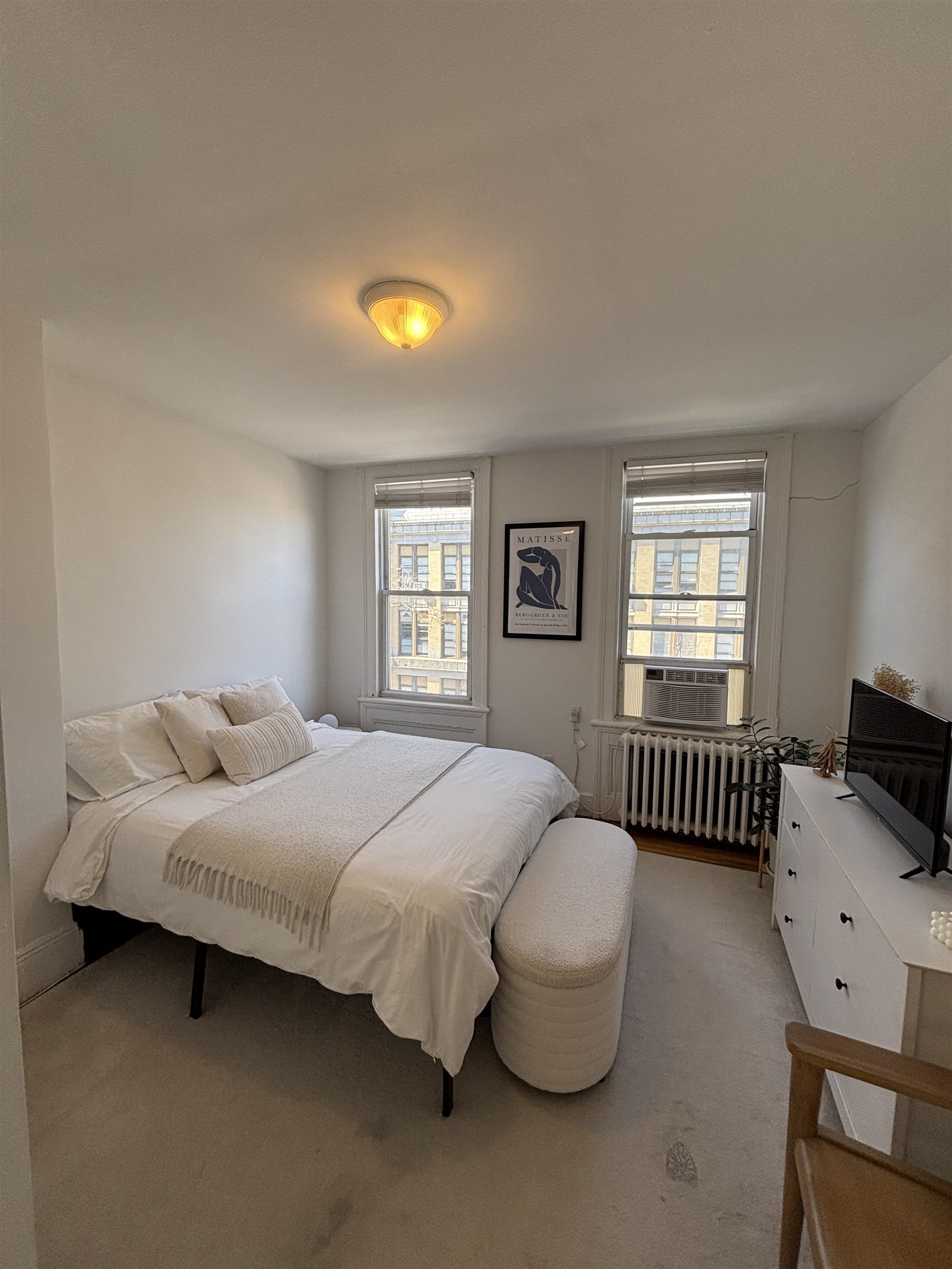 409 Bloomfield Street, Unit 8 Hoboken, NJ 07030 - Photo 3 of 5 a bedroom with a bed and a window