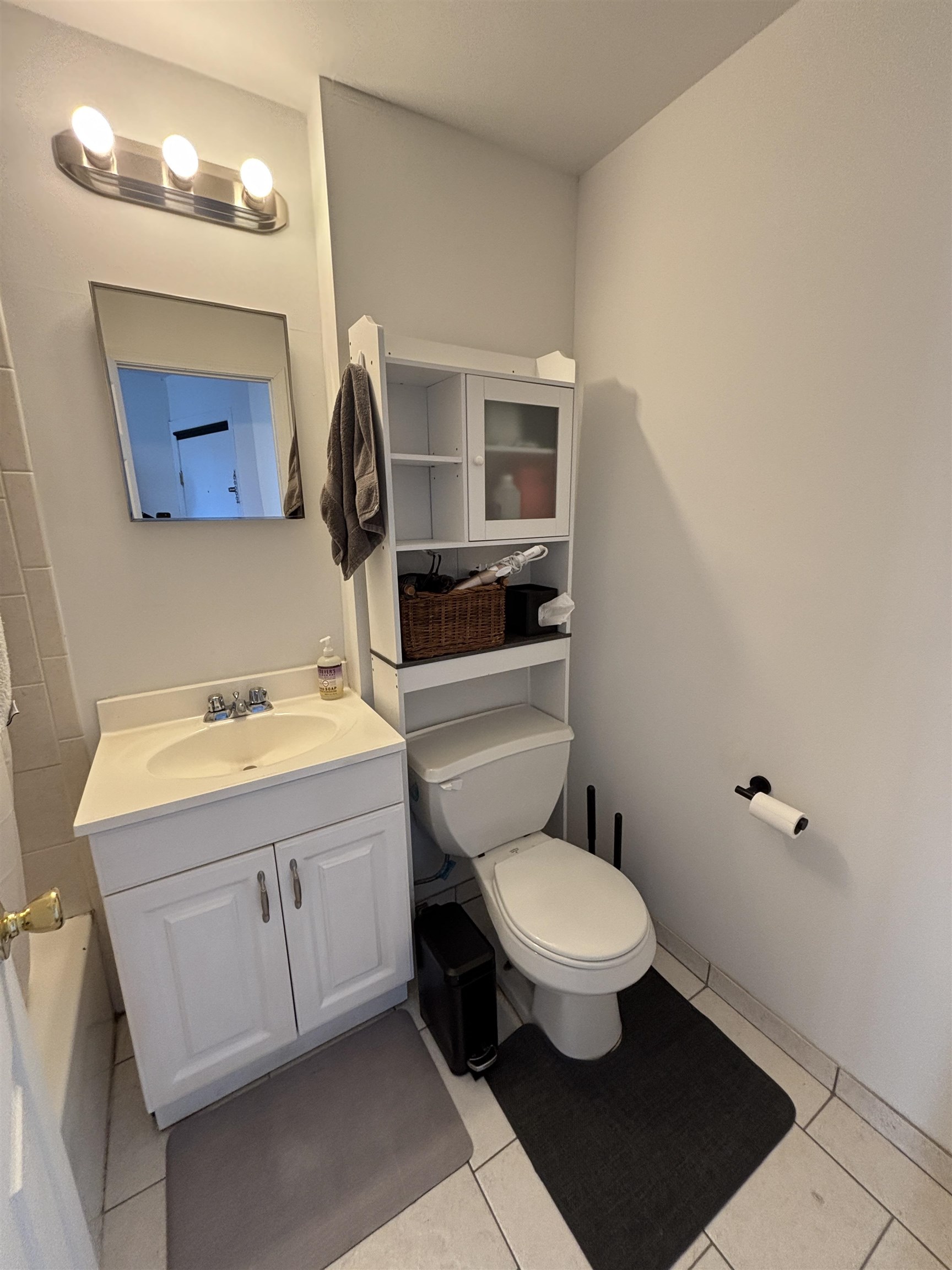 409 Bloomfield Street, Unit 8 Hoboken, NJ 07030 - Photo 4 of 5 a bathroom with a toilet sink and mirror