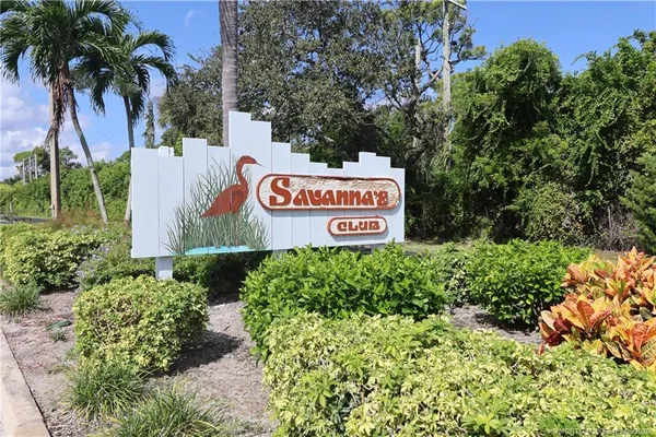 a sign that is sitting in front of flowers