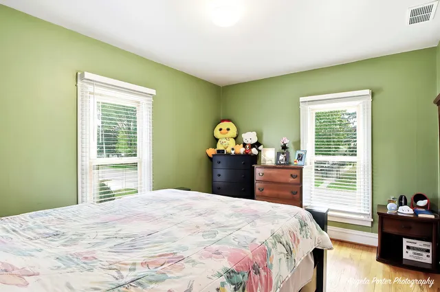 a bedroom with a bed table and a window