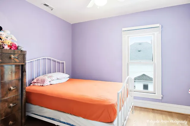 a bedroom with a bed and a window