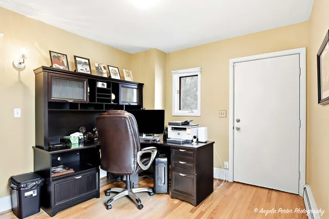 a view of a workspace with furniture and natural light