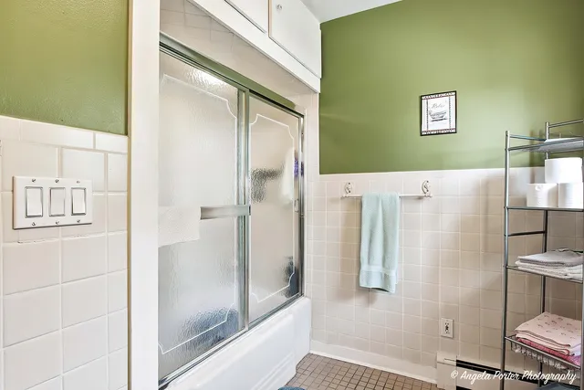 a bathroom with a shower and a mirror