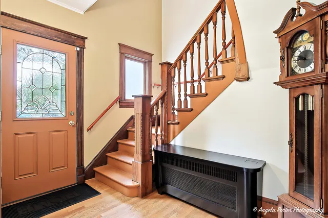 a view of an entryway with wooden floor and door