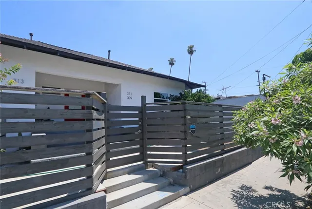 a view of a chairs and tables back yard of the house